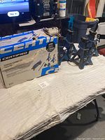 Photo showing the assembled jack stands next to the original product box.