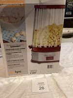 Box of EasyPop popcorn maker showing product features and images of popcorn.