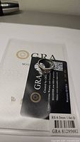 Ring on GRA certificate card showing certificate number GRA 81295682 and spec label RS 6.5 mm 1.0 ct D