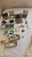 Overview image showing all jewelry items and boxes arranged on surface