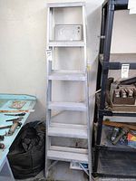 Full view of the Keller aluminum step ladder with five steps, showing height and general condition.