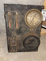 Front view of the pressure regulator panel showing pressure gauge, dual fuses, and company label plate.