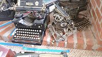 Full view of black Royal branded typewriter and an additional typewriter mechanism showing two separate items.