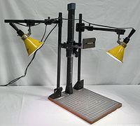 Full frontal view showing the entire Bessler CS-14 photocopy stand with two yellow Smith Victor A5 light fixtures extended.