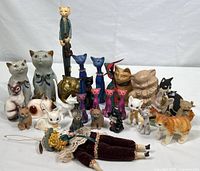 Full view of all cat figurines grouped together showing size variation and materials.