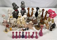 Full view of entire collection showing multiple ceramic, wooden and plastic poodles of different sizes, colors, and styles arranged closely together.