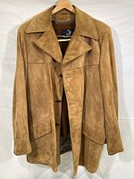 Front view of tan suede men's jacket showing collar, buttons, and pocket detail