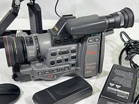 Overall side view of Canon A1 Digital Hi8 video camera showing lens, body, and battery pack.