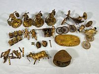 Overview of the lot laid out on white background showing figurines, carts, and animal miniatures with many loose parts