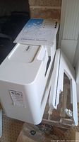 White Brother sewing machine with hard protective case, partially open, showing the top and side panel.