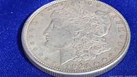 Obverse side of the 1921 Morgan silver dollar coin showing Lady Liberty profile and date 1921.