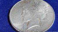 Close-up image of the 1922 Morgan silver dollar coin showing Liberty side with inscriptions.