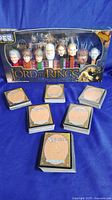 Full set of 7 Lord of the Rings PEZ character dispensers in original box with seven visible Magic The Gathering card stacks arranged in front.