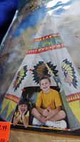 Photo showing packaging with a picture of the outdoor kids teepee and two children inside, highlighting the colorful design and size.