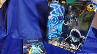 Wide view showing Tron Legacy arcade game case and boxed Sam Flynn figure
