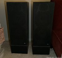 Front view of two B&W black floorstanding speakers side by side