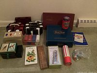 Photo showing a collection of card and board games including poker chip sets, playing cards, cribbage boards, dice, Trivial Pursuit, and Scrabble.