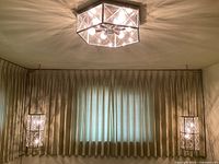 Two rectangular pendants hanging by chains with octagonal flush mount installed on ceiling