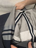 Close-up of the queen size comforter showing gray and white stripes and fabric texture.