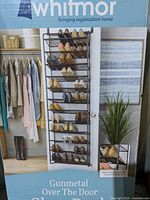 Full shoe rack hanging over a door holding shoes to show use and design