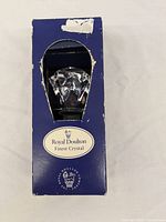 Original box showing star-shaped cutout allowing view of crystal bottle stop inside, box has visible wear and tear.