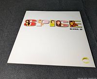 Front cover of the vinyl record album SPICE by Spice Girls with colorful lettered title and images in letters
