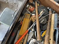 Opened drawer showing various hand tools including hammers and screwdrivers