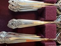 Close-up of the floral ornate handle details of the silver plated cutlery.