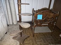 Vintage 4-tier wooden plant stand next to antique wooden magazine rack showing general condition and design