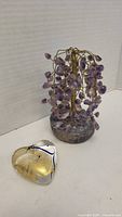 Amethyst tree and Robert Held glass heart displayed on a plain surface, showing full view of both items.