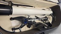 Photo showing Tasco telescope tube with tripod mount inside carrying case