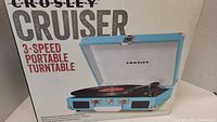 Box showing Crosley Cruiser 3-speed portable turntable branding and product image.