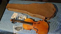 Violin, hard case, loose accessories overview