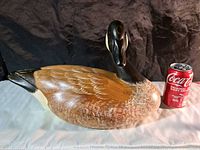 Side view of the full wooden Canada goose decoy with Coke can for scale