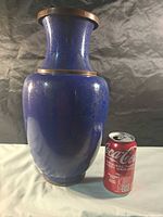 Full view of blue cloisonné vase beside soda can for scale