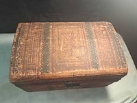 Top view of wooden trunk showing surface wear and decorative border