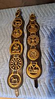 Both leather straps with all brass plaques visible