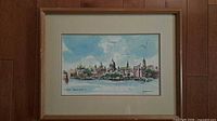 Full view of framed artwork showing mat and wood frame