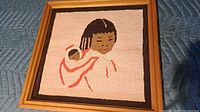 Front view of framed hooked rug showing full design