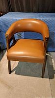 Front view of tan vinyl accent chair