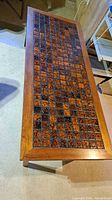 full view of table top showing mosaic tiles and wood frame