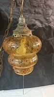 Full view of amber crackle glass pendant with chain
