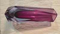 Top angled view showing clear exterior and purple core, faceted shape