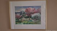 Framed watercolor landscape painting under glass