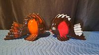 Front view of both ceramic fish wall pockets facing each other
