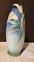 Front view of vase showing calla lily relief and ombre glaze
