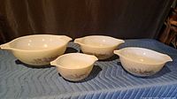 Four nested Pyrex Forest Fancies bowls showing size range