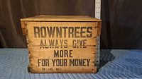Front view showing stenciled Rowntrees advertising text and lid