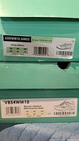 Box labels showing model numbers, size, color for both pairs