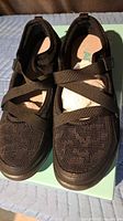 Top view of both sneakers showing knit mesh upper and elastic straps